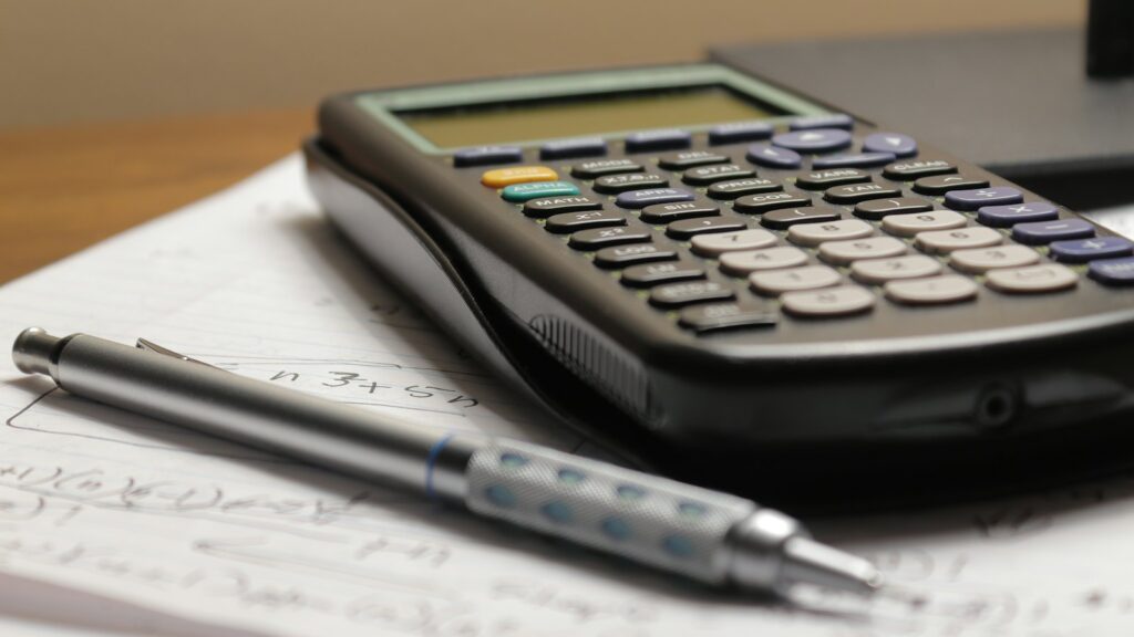 Calculadora y bolígrafo para calcular el IVA de una reforma
